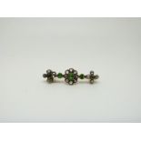 An early Victorian brooch set with rose cut diamonds and tsavorite demantoid garnets,