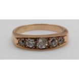 A 9ct gold ring set with five graduated old cut diamonds, centre diamond approximately 0.