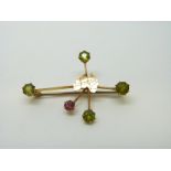 A 15ct gold brooch set with peridot and a pink topaz with an outline of Australia to the centre