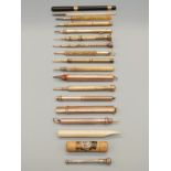 A collection of antique pens including 9ct gold, inlaid bone,