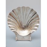 A Victorian hallmarked silver shell shaped dish raised on three feet shaped as molluscs,