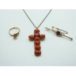 A yellow metal cross set with rose cut oval coral cabochons,