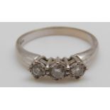 An 18ct white gold ring set with three diamonds (size O)