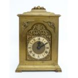 A brass carriage style / bracket clock, the keyless movement stamped Rotherham, England,