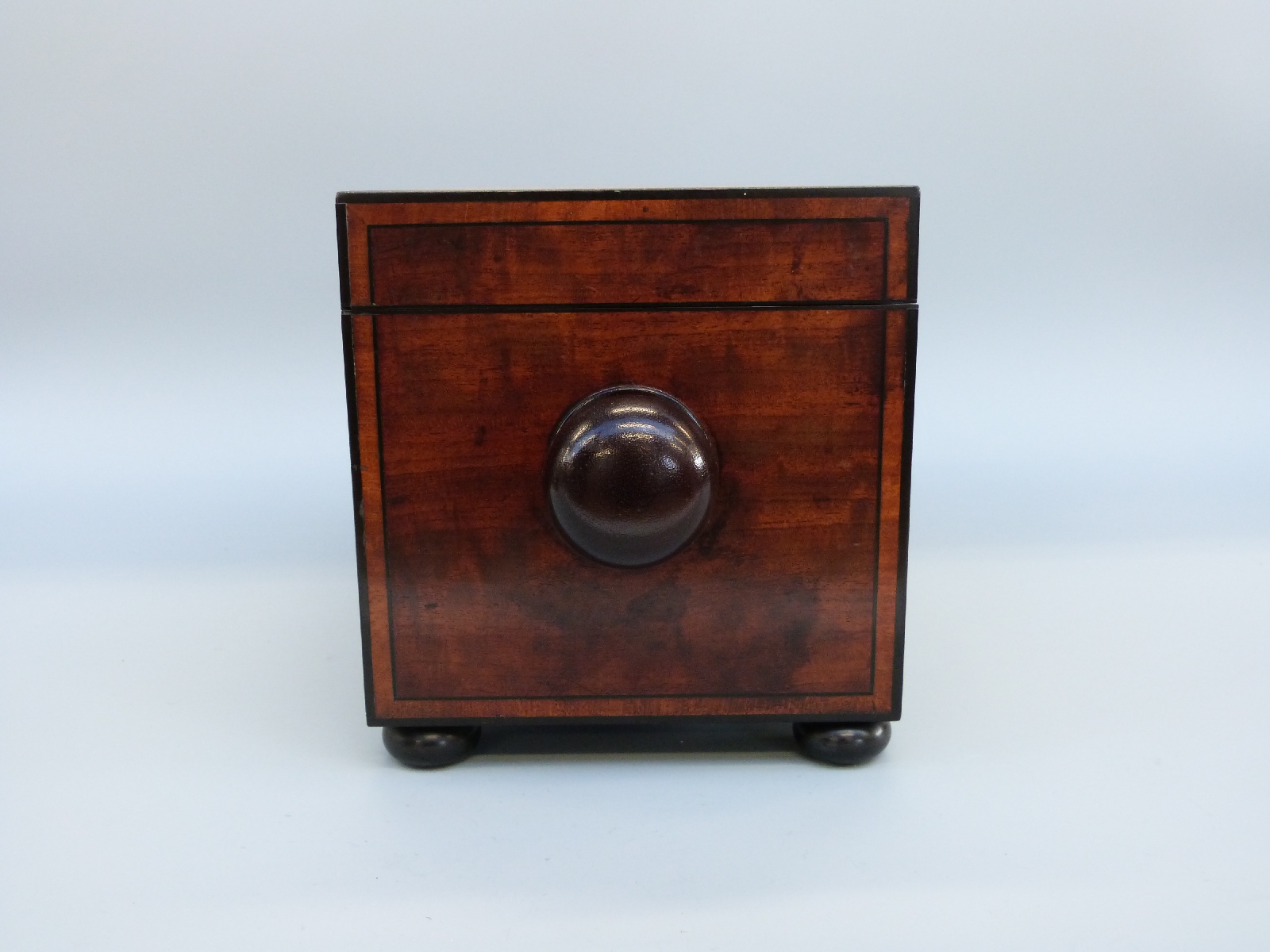 An early 19thC mahogany tea caddy of rectangular form with inlaid ebony detail, raised on bun feet, - Image 6 of 8