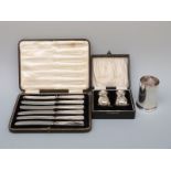 A hallmarked silver spill holder, Birmingham, a cased pair of peppers,