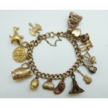 A 9ct gold charm bracelet with eleven 9ct gold charms including a crown, St Christopher, purse,