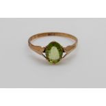 A 9ct gold ring set with an oval peridot (size P)