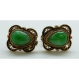 A pair of earrings set with a pear cut jade cabochons