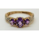 A 9ct gold ring set with amethysts and diamonds (size O)