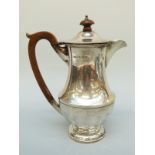 A George V hallmarked silver hot water jug, Birmingham 1930, maker Harford Case Co.