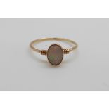 A 9ct gold ring set with an opal cabouchon (size J)