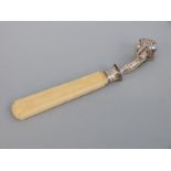 A French white metal ivory handled ham holder or clamp, with lion's claw decoration to clamp,