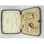 A cased set of 9ct gold cufflinks and studs set with mother of pearl and a blue cabochon to each
