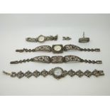 Three silver and marcasite watches a marcasite bracelet and a silver and marcasite ring set with a
