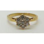 An 18ct gold ring set with diamonds in a cluster, total diamond weight approximately 0.5ct, 3.