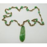 A 14ct gold filigree necklace set with jadeite beads and a carved jadite plaque