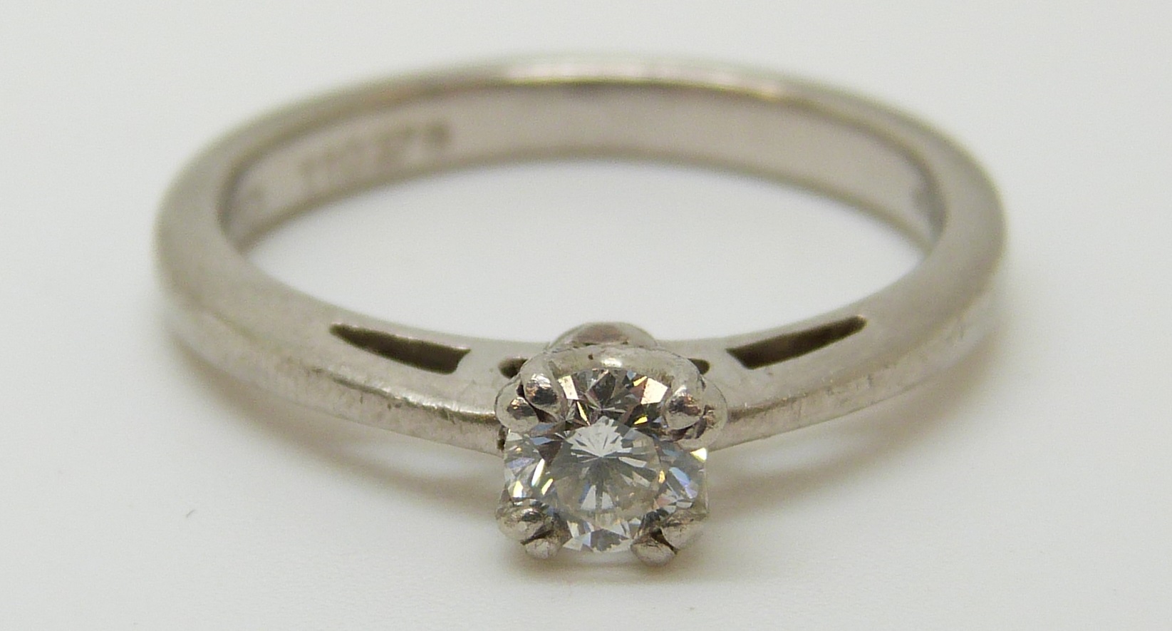 A platinum ring set with a diamond of approximately 0.28ct, 4.