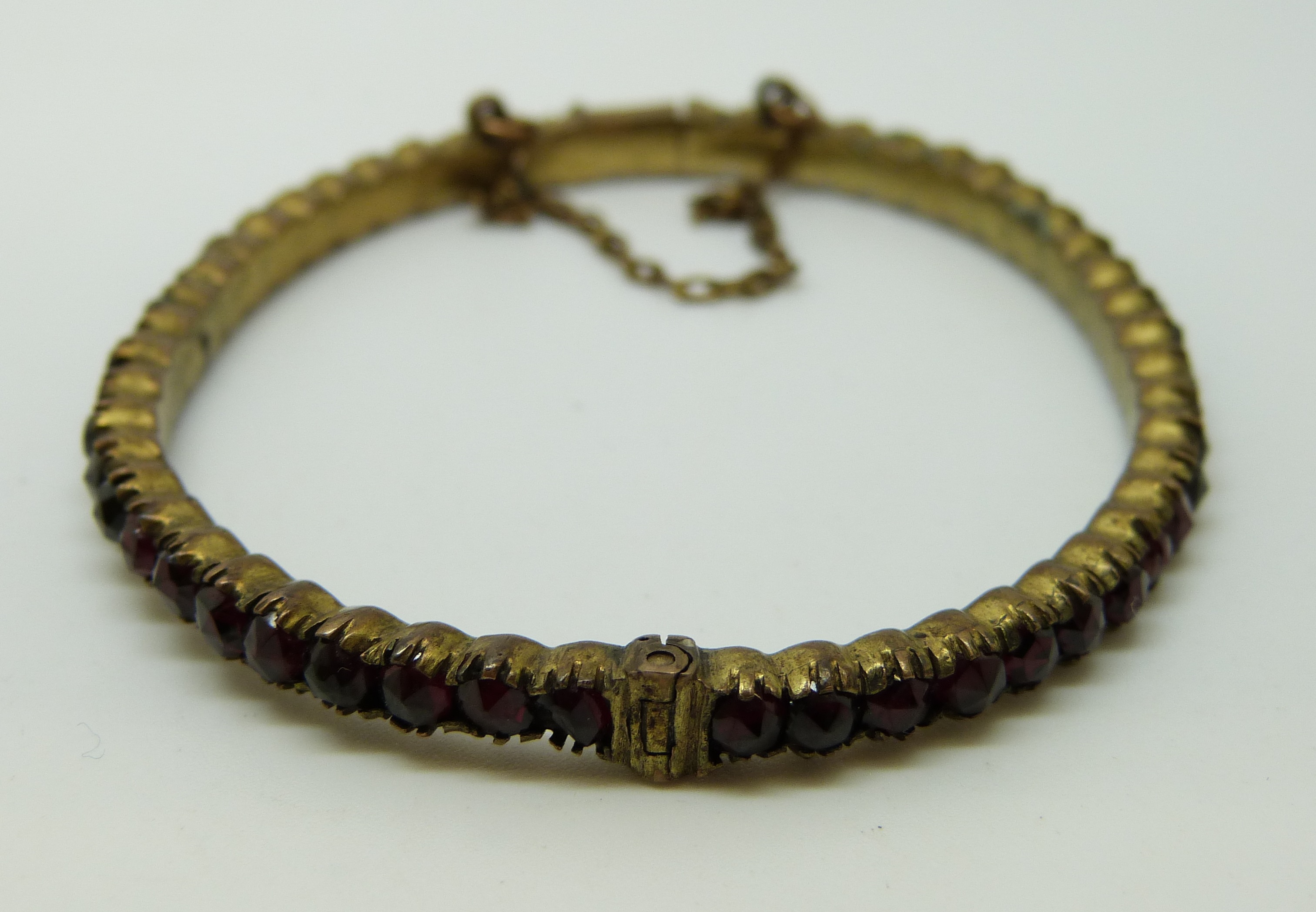 A Victorian bangle set with garnets