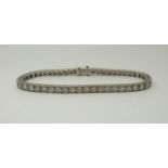 A Tiffany & Co palladium tennis bracelet set with 50 round brilliant cut diamonds each