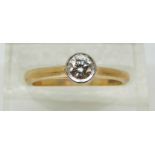 An 18ct gold ring set with a round cut diamond of approximately 0.23ct, 3.