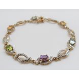 A 9ct gold bracelet set with diamonds and various gemstones, 9.