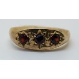 A 9ct gold ring set with three garnets (size V)