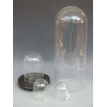 Four various glass clock domes, 51cm tall, 20cm diameter,