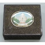 An early 20thC Anglo Indian carved ebony box with inset oval miniature of the Taj Mahal,