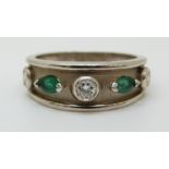 A 9ct white gold ring set with diamonds and emeralds (size O)