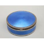 A white metal and blue guilloché enamel hinged compact or pill box with seed pearl border with