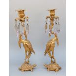 A pair of 19thC gilt bronze candelabra in the form of cranes on turtles in the Japanese style,