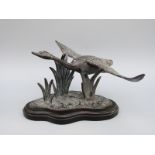 A bronze or similar model of a swan in flight,