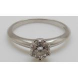 A Tiffany & Co platinum ring set with a round brilliant cut diamond of approximately 0.