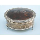 A George V hallmarked silver tortoiseshell lidded dressing table pot, Birmingham 1926,