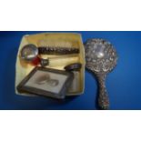 A silver hand mirror; together with a silver photograph frame and four other items.