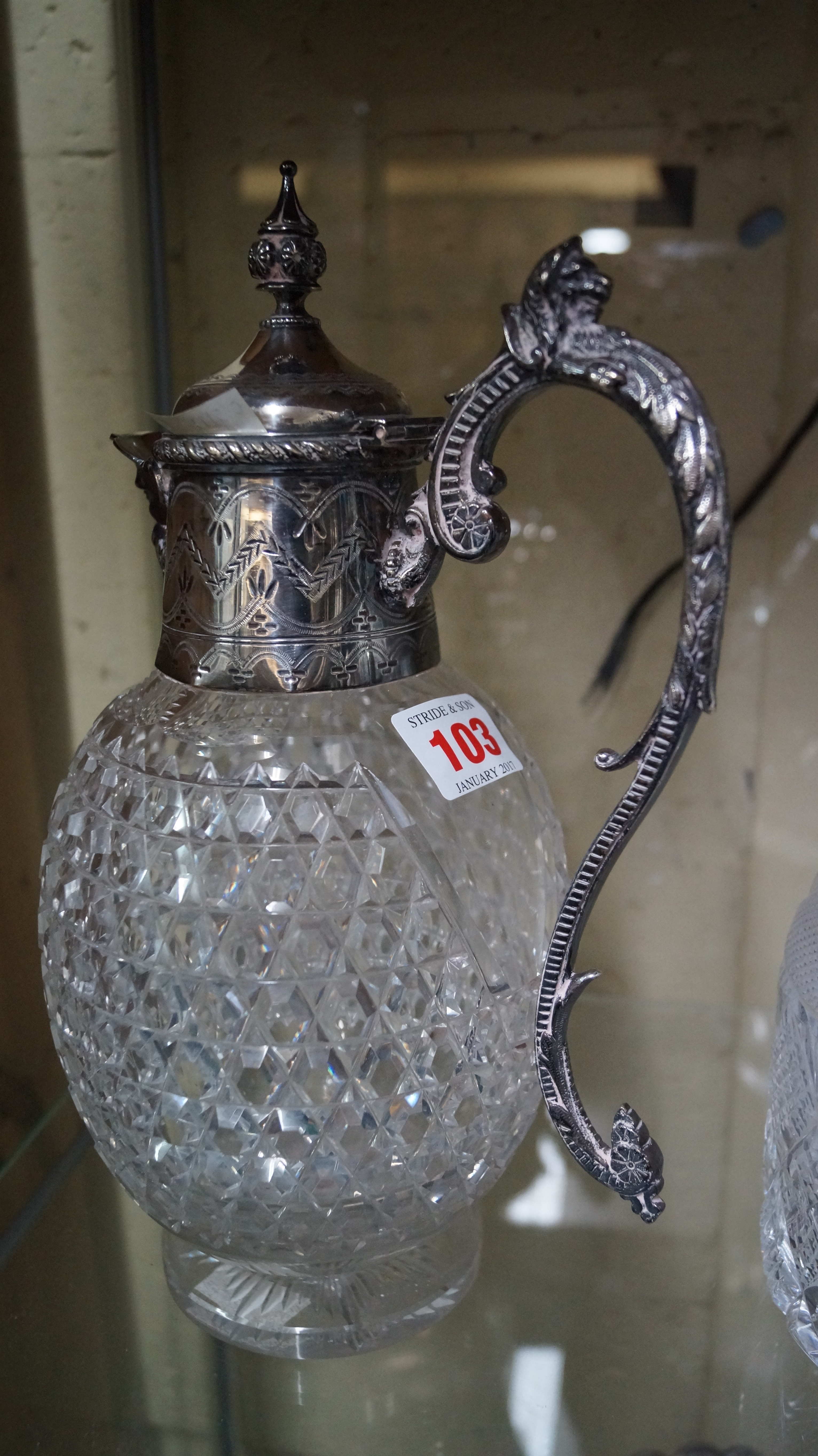 A cut glass and electroplate mounted claret jug.