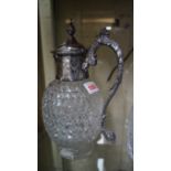 A cut glass and electroplate mounted claret jug.