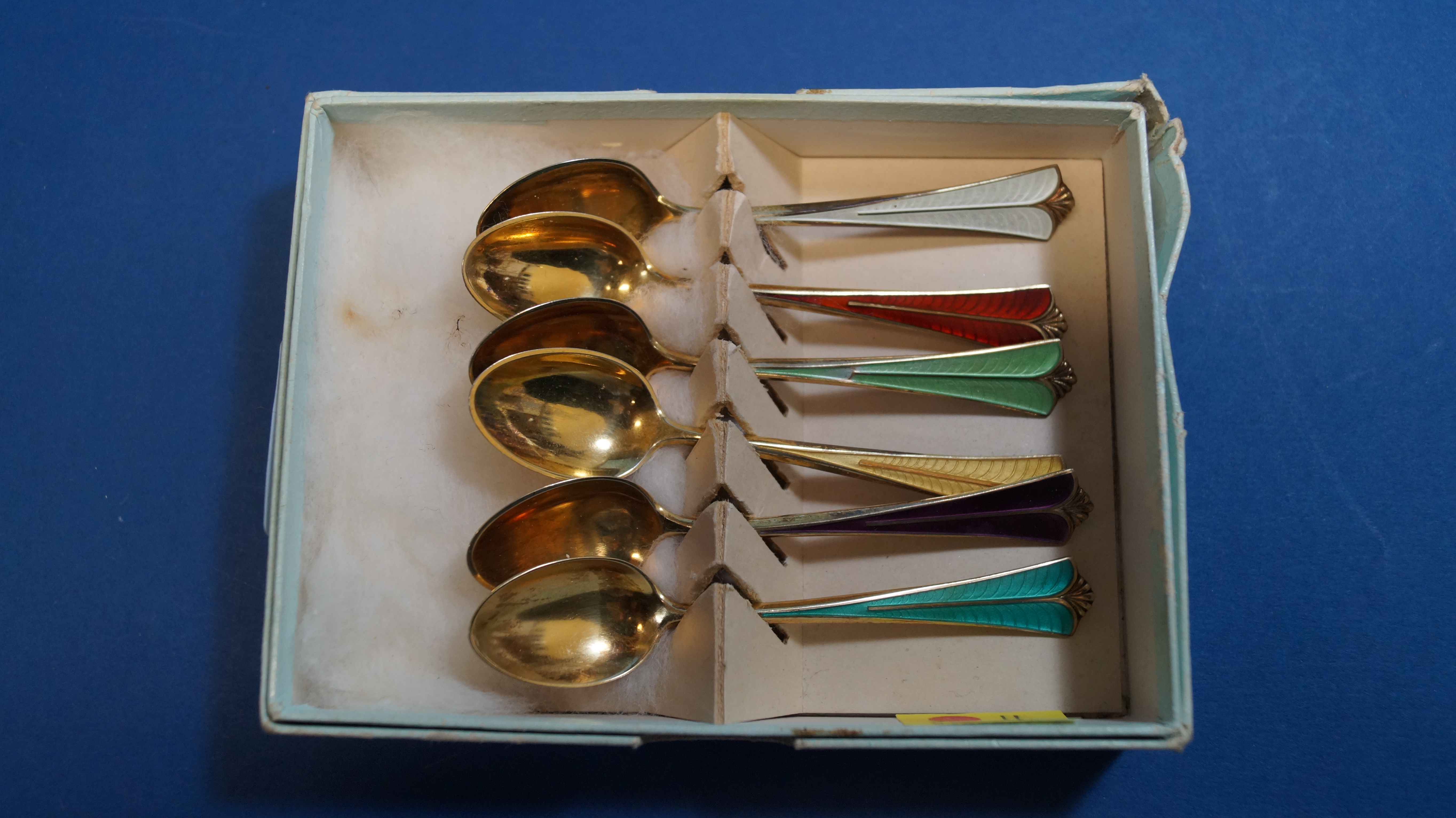 A boxed set of six silver gilt and enamel coffee spoons, by D A, 10cm.