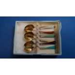 A boxed set of six silver gilt and enamel coffee spoons, by D A, 10cm.