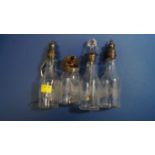 Four Victorian silver mounted condiment bottles; together with a Victorian silver condiment spoon,