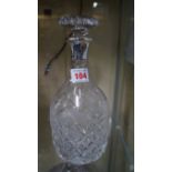 A silver mounted cut glass decanter and stopper.