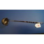 A 19th century metal wine ladle having twisted whalebone handle. 36cm.