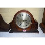 A 1920s oak mantel clock, 32.5cm wide.