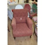 A Victorian mahogany and button upholstered tub armchair.