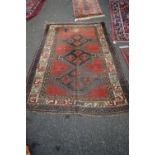 A triple medallion Kazak rug, 216 x 140cm.