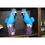 A pair of Chinese blue and purple glazed cockerels, 25cm high.