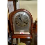A late 19th century dome top mahogany mantel clock, with silvered dial, 28cm high.
