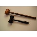 A treen gavel, 25cm long; together with another ebony example, 15.5cm long.