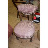 A Victorian walnut and upholstered nursing chair.